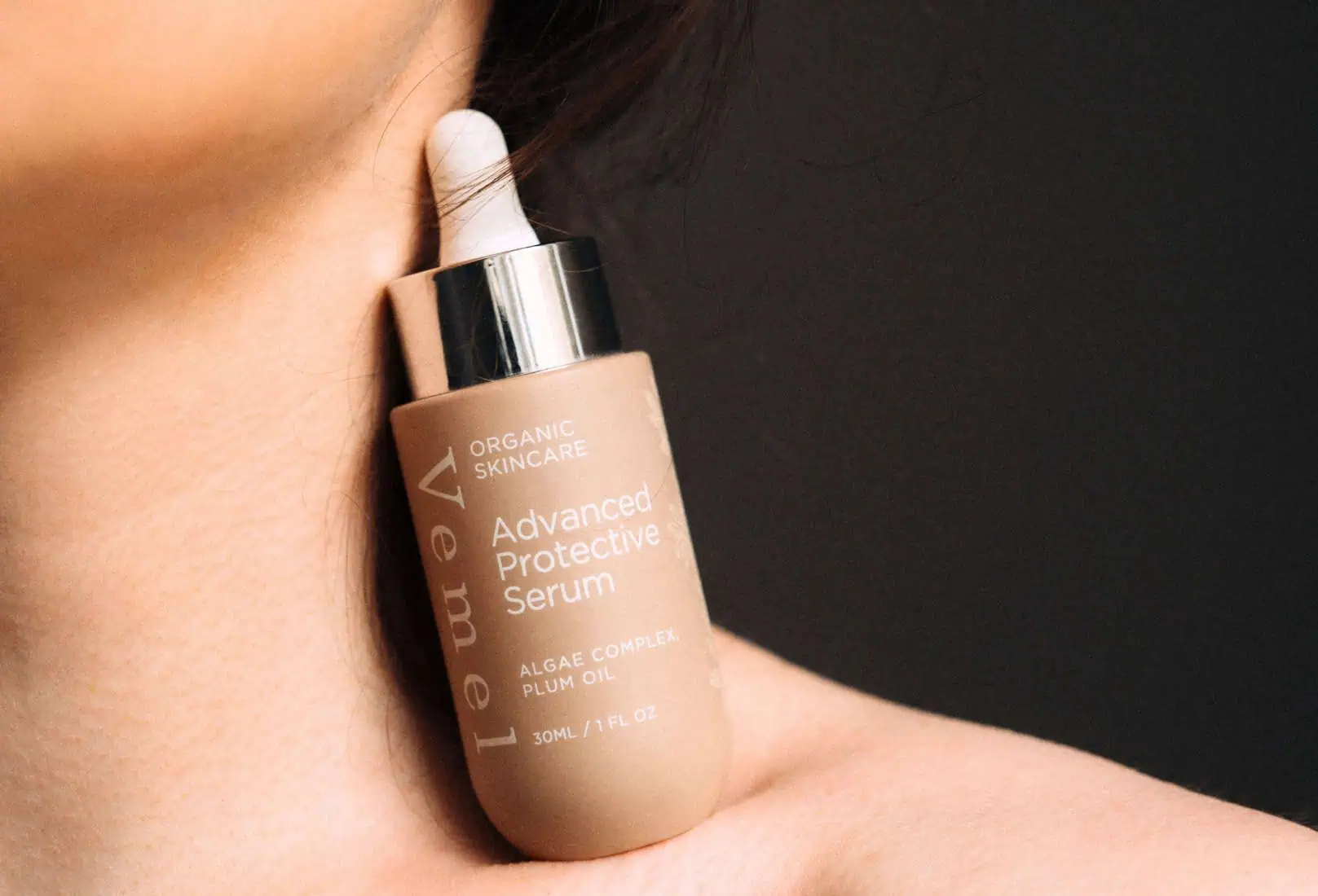 Woman applying organic serum to support dry, menopausal skin – Vemel skincare