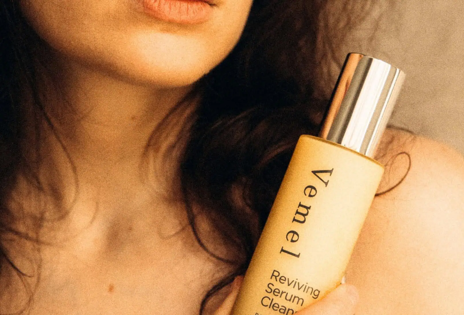 Woman holding Reviving Serum Cleanser — organic skincare supporting the skin microbiome