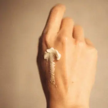 Waterless organic face cream texture on hand for sensitive