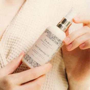 Holding organic cleansing oil during skincare routine