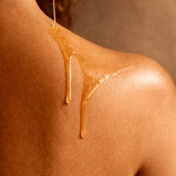 Vemel waterless organic Marigold Nectar body oil applied on shoulder showing nourishing oil texture