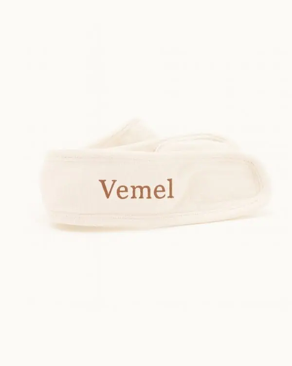 Organic cotton headband for skincare rituals on cream background